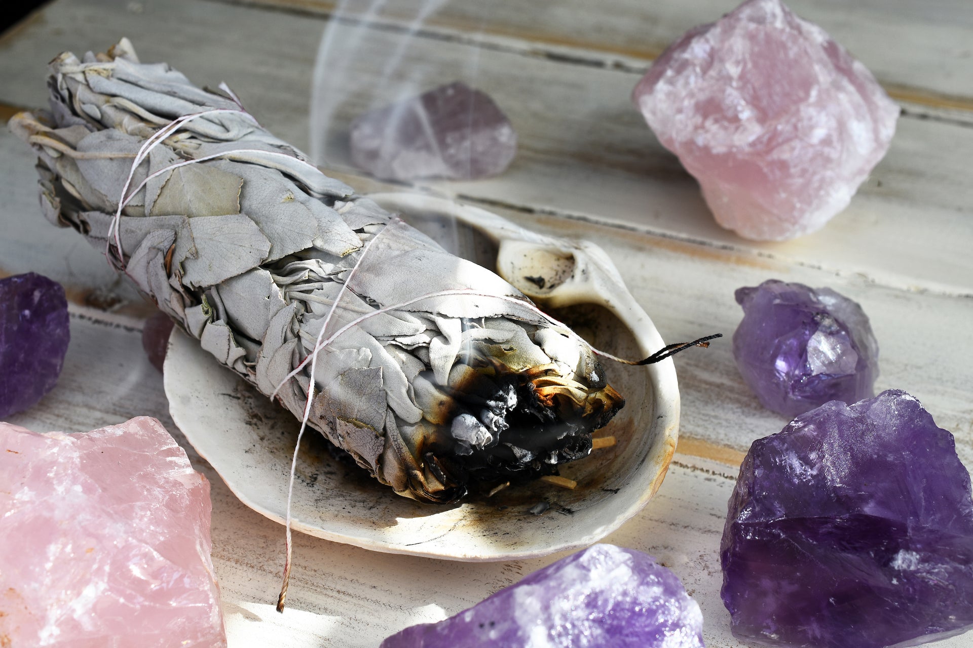 White burning sage with amethyst and rose quartz stones